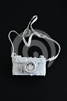 Vintage film camera painted with wall paint on black