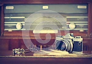 Vintage film camera and retro radio background