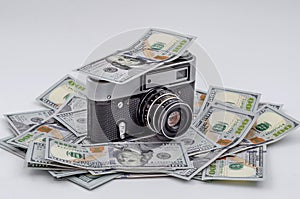 Vintage film camera on scattered American dollars