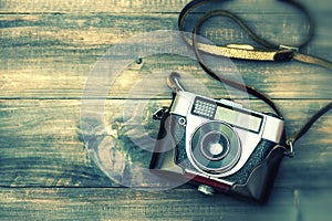 Vintage film camera on wooden background. Instagram style