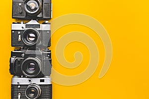 Vintage Film Cameras On Yellow Background Surface. Creativity Retro Technology Concept