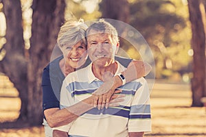 Vintage filter portrait of American senior beautiful and happy mature couple around 70 years old showing love and affection smilin