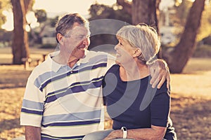 Vintage filter portrait of American senior beautiful and happy mature couple around 70 years old showing love and affection smilin