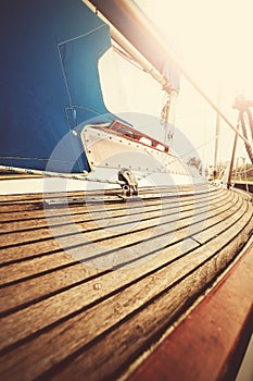 Vintage filtered close up picture of yacht deck and rigging.