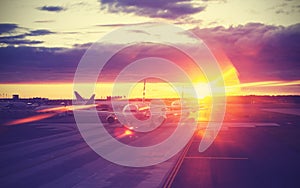 Vintage filtered picture of airport at sunset, travel concept.