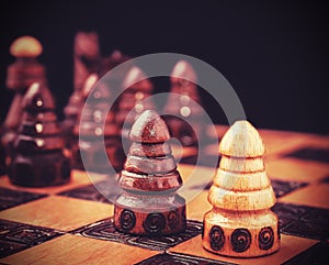 Vintage filtered picture of chess, one against all concept.