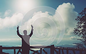 silhouette of man making peace gesture two hands