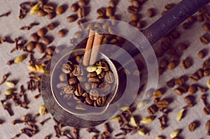 Vintage filtered turkish coffee pot filled with coffee beans on canvas background