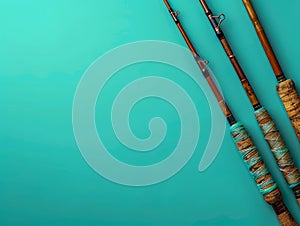 Vintage Fishing Rods Aligned on Vivid Teal Background with Space for Text, Angling Equipment Top View photo