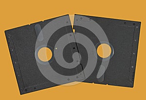 Vintage Floppy Disk 5.25 inch. Retro storage technology isolated on orange background