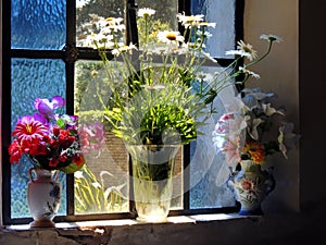 Vintage flower vases on old window