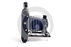 Vintage folding bellows roll film camera on white background