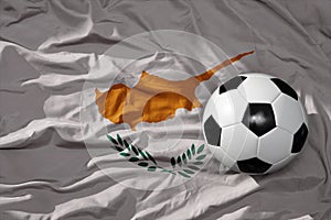 Vintage football ball on the waveing national flag of cyprus background. 3D illustration photo