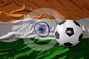 Vintage football ball on the waveing national flag of india background. 3D illustration