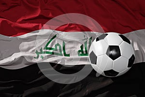 Vintage football ball on the waveing national flag of iraq background. 3D illustration