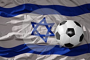 Vintage football ball on the waveing national flag of israel background. 3D illustration