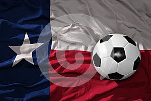 Vintage football ball on the waveing texas state flag background. 3D illustration