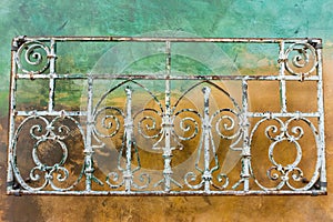 Vintage forged iron ornaments; colorful wall background, California