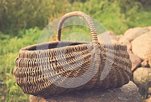 Vintage foto of Empty basket / Braided basket basket on green lawn