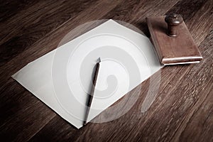 Vintage fountain pen and empty sheet of paper on a wooden table