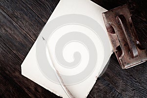 Vintage fountain pen and empty sheet of paper on wooden table