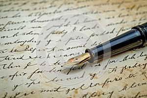 Vintage fountain pen with gold nib on old paper, perfect for themes of love letters, Valentine's Day, or historical