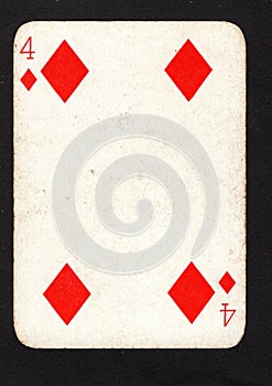 A vintage four of diamonds playing card on a black background.