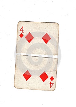 A vintage four of diamonds playing card torn in half.