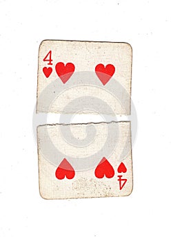 A vintage four of hearts playing card torn in half.