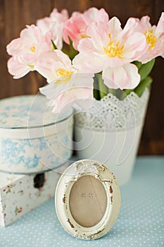 Vintage frame with bow decoration. Gift boxes with flower ornament. Bouquet of tulips with pink and white petals