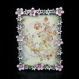 Vintage frame with floral ornament on black background.