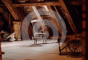 Vintage furniture in abandoned house. Old rocking chair in rustic vintage style attic