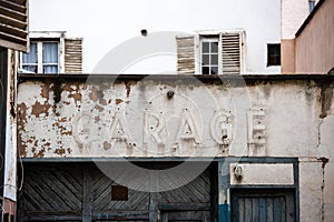 Vintage garage inscription on the old rusty door in central Strasbourg