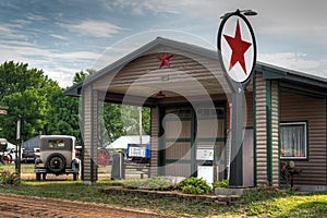 Vintage Gas Station with Old Car Parked Outside