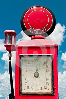 Vintage Gasoline Pump Against Cloudy Blue Sky