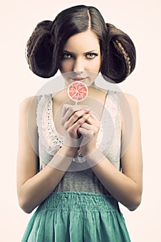 Vintage girl with lollipop, she looks at right