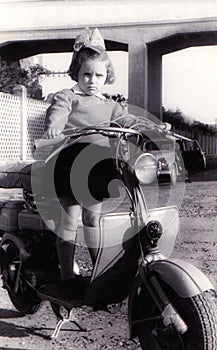 Vintage girl on old scooter