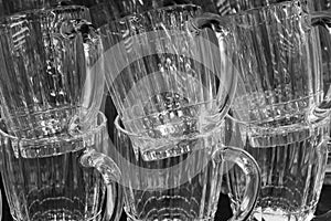 Vintage glass beer mugs with ribbed surface, glass background