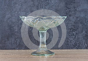 Vintage glass vase for fruit on a wooden table