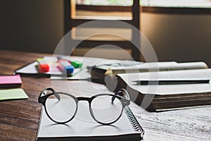 vintage glasses on books stack in public library book, Studying examining Tutor books with friends. Young students campus helps