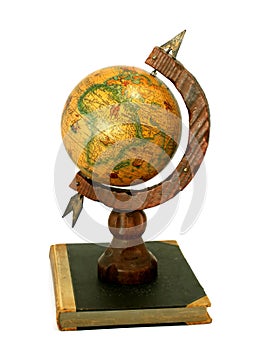 Vintage globe on old book isolated on white