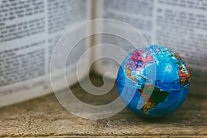 Vintage globe with open Bible photo