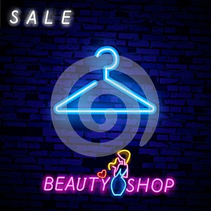 Vintage Glow Signboard with Hanger, Shopping Concept. Atelier, Checkroom, Tailor, Dressmaker, Boutique. Shiny Neon Light photo