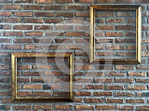 Vintage gold empty picture frame in portrait and landscape orientation hang on exposed terra cotta brick wall background