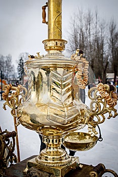 Vintage gold-plated Russian samovar on a street