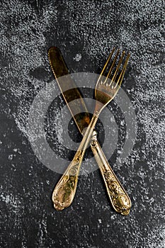 Vintage golden dinner set on a grundge blue background