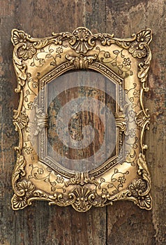 Vintage golden frame on wooden background. Grunge texture