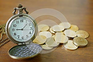 Vintage golden pocket watch with stack on wood table background