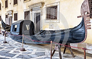 Vintage gondola at Doge`s Palace or Palazzo Ducale, Venice, Italy. Gondola is a most attractive tourist transport of Venice