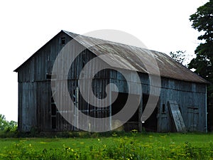 Vintage gray hay barn in Fingerlakes countryside during summer